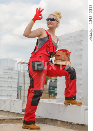 Woman working with bricks 134243318