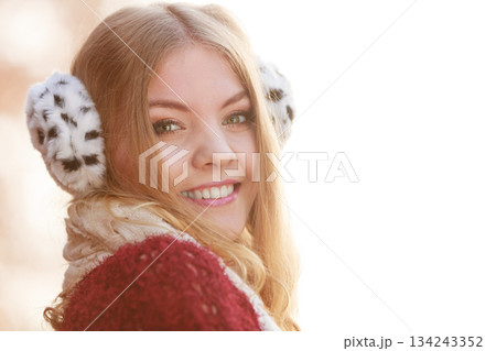 Pretty gorgeous woman in earmuffs. Pretty gorgeous woman in earmuffs. 134243352
