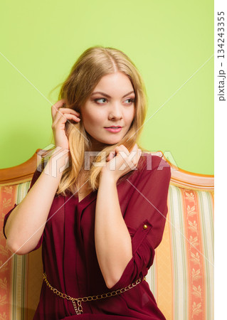 Pretty young woman on vintage sofa. Fashion. 134243355