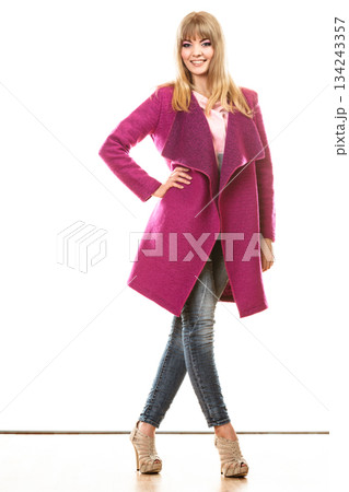 blonde fashionable woman in vivid color coat. blonde fashionable woman in vivid color coat. 134243357