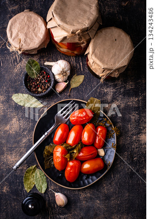 Marinated pickled tomatoes in jar 134243486