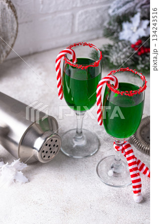 Christmas green cocktail punch with candy cane 134243516