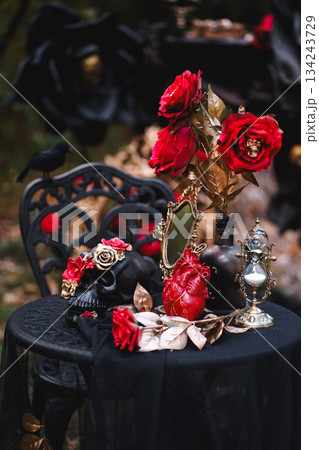 Gothic Halloween Table Setting with Skulls and Red Roses Gothic Halloween Table Setting with Skulls and Red Roses 134243729