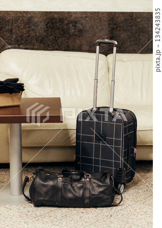 Suitcase and bag in a lobby Suitcase and bag in a lobby 134243835