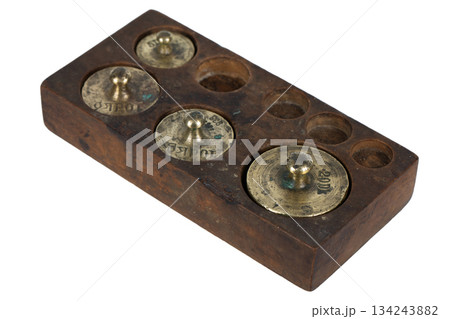 wooden box with scale weights set on white 134243882