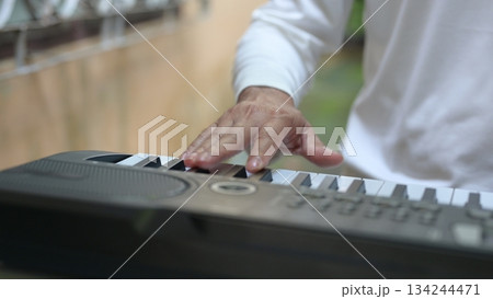 Close Up Hands Serene Music Performance On Black Keyboard, White Keys, For Relaxation 134244471