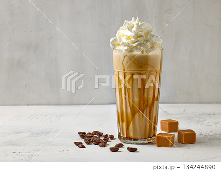 glass of caramel latte with whipped cream 134244890