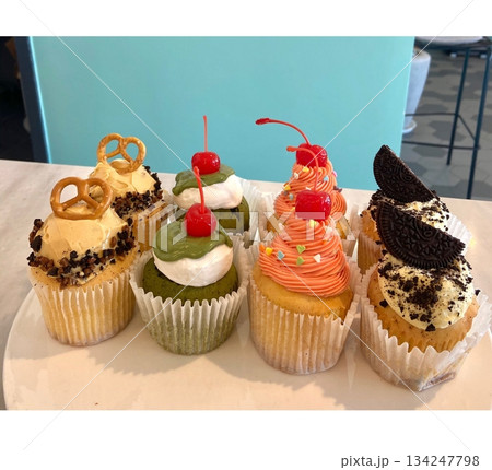 A delightful cupcake topped with rich frosting and decorative sprinkles. Perfect for dessert photography, showcasing the charm and sweetness of baked goods, ideal for parties and celebrations. 134247798