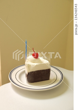 Rich and velvety chocolate cheesecake slice with a smooth, creamy texture and deep cocoa flavor. A perfect balance of indulgence and sweetness for a decadent dessert experience. 134248543