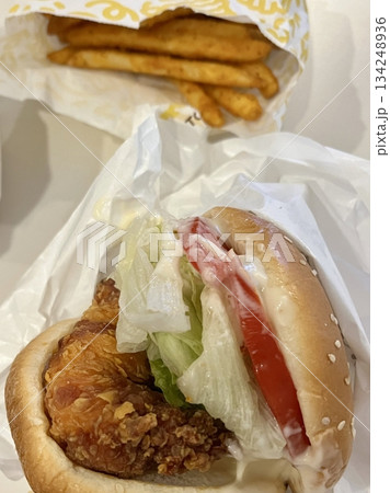 A classic combination of a juicy burger with fresh toppings served alongside golden, crispy French fries. Perfect for a satisfying meal that blends savory flavors and crunchy textures. 134248936