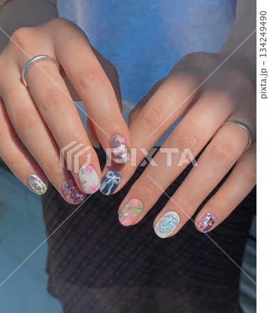 Beautiful nail art with intricate designs and vibrant colors, showcasing glossy finish, smooth texture, and detailed patterns in close-up view 134249490