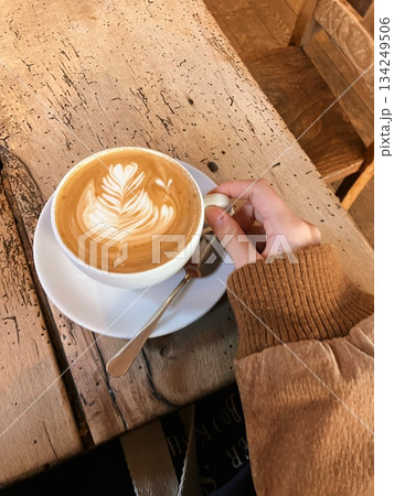 A beautifully crafted latte, featuring creamy foam art on top of rich espresso. Perfect for coffee-related projects, this image captures the warmth and inviting nature of a classic café experience. 134249506