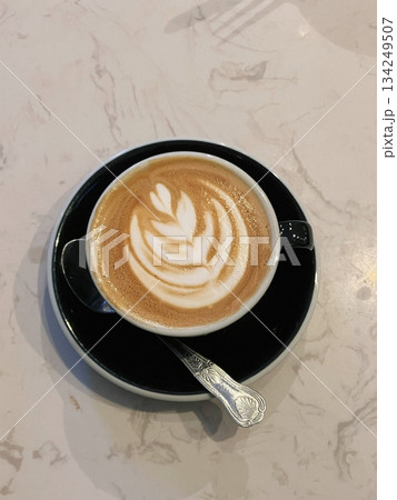 A beautifully crafted latte, featuring creamy foam art on top of rich espresso. Perfect for coffee-related projects, this image captures the warmth and inviting nature of a classic café experience. 134249507