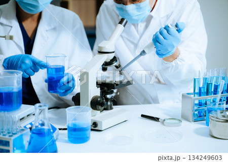 Scientist team with tablet and laptop, laboratory and ecofriendly science. Agriculture, research and scientists with online reading 134249603