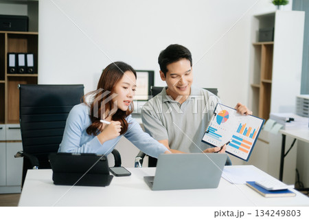 Male discussing new project with male colleague. Young woman talking with young man 134249803