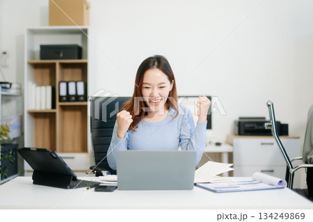 Business woman using tablet and laptop for doing math finance on an office desk, tax, Business woman using tablet and laptop for doing math finance on an office desk, tax, 134249869