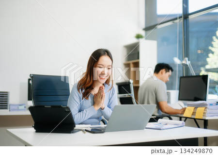 Business woman using tablet and laptop for doing math finance on an office desk, tax, 134249870