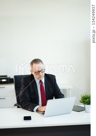 Professional businessman working at office with laptop, tablet, and notes. Perfect for business, finance, accounting, Professional businessman working at office with laptop, tablet, and notes. Perfect for business, finance, accounting, 134249937
