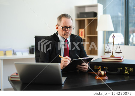 Man lawyer working and gavel, tablet, laptop in front, Advice justice and law concept. Man lawyer working and gavel, tablet, laptop in front, Advice justice and law concept. 134250073