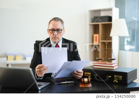 Male judge in courtroom, lawyer working in office. Perfect for business, legal advice, corporate law Male judge in courtroom, lawyer working in office. Perfect for business, legal advice, corporate law 134250080