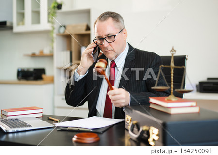 Caucasian male judge in courtroom, lawyer working in office. Perfect for business, legal advice, corporate law 134250091