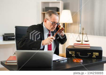 Male judge in courtroom, lawyer working in office. Perfect for business, legal advice, corporate law Male judge in courtroom, lawyer working in office. Perfect for business, legal advice, corporate law 134250093