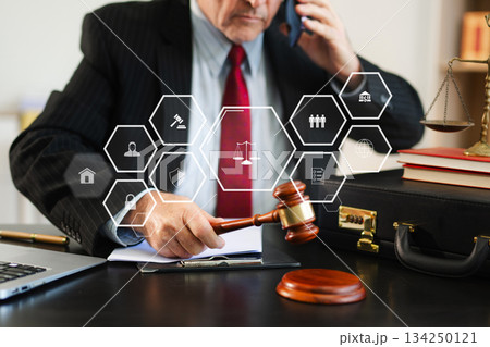 justice and law concept. Male judge in a courtroom the gavel, working with smart phone and laptop and digital tablet justice and law concept. Male judge in a courtroom the gavel, working with smart phone and laptop and digital tablet 134250121