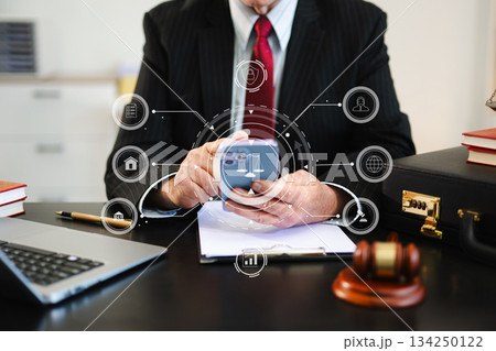 justice and law concept. Male judge in a courtroom the gavel, working with smart phone and laptop and digital tablet justice and law concept. Male judge in a courtroom the gavel, working with smart phone and laptop and digital tablet 134250122