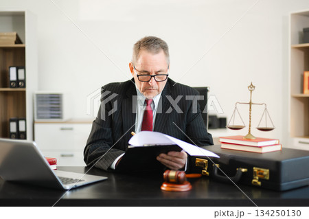 Professional male lawyers consulting on legal cases in a modern office. Perfect for law, business, justice, legal advice, corporate attorneys 134250130