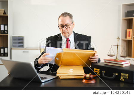 Caucasian male judge in courtroom, lawyer working in office. Perfect for business, legal advice, corporate law Caucasian male judge in courtroom, lawyer working in office. Perfect for business, legal advice, corporate law 134250142