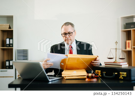 Professional male lawyers consulting on legal cases in a modern office. Perfect for law, business, justice, legal advice 134250143