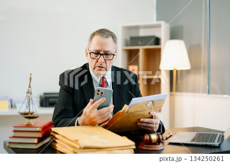 Professional male lawyers consulting on legal cases in a modern office. Perfect for law, business, justice, legal advice 134250261