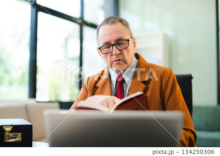 Mature Male judge in a courtroom on white table and Counselor or Male lawyer working in office. Justice and law concept Mature Male judge in a courtroom on white table and Counselor or Male lawyer working in office. Justice and law concept 134250306