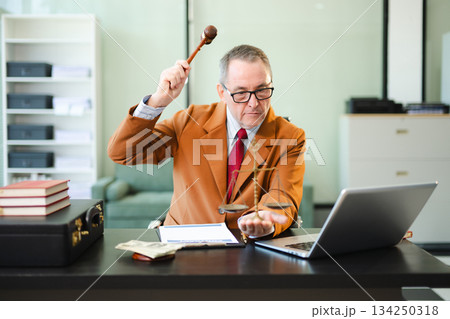 Mature Male judge in a courtroom on white table and Counselor or Male lawyer working in office. Justice and law concept Mature Male judge in a courtroom on white table and Counselor or Male lawyer working in office. Justice and law concept 134250318