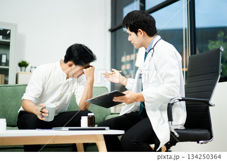 Caring doctor supports stressed male patient during mental health consultation on sofa. Therapy, empathy, and emotional care Caring doctor supports stressed male patient during mental health consultation on sofa. Therapy, empathy, and emotional care 134250364