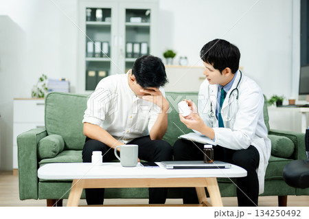 Doctor giving emotional support and medication advice to stressed male patient. Mental health, therapy, and care 134250492