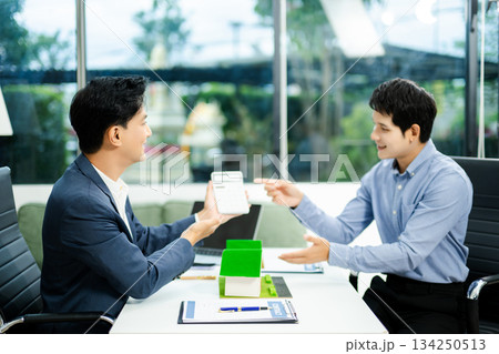 Real estate broker agent presenting and consult to customer to decision making sign insurance form agreement, home model 134250513