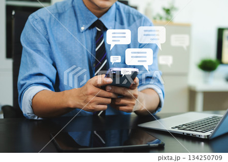 Man hands User typing on smartphone and tablet chatting conversation in chat box icon pop up for social media marketing technology concept. Man hands User typing on smartphone and tablet chatting conversation in chat box icon pop up for social media marketing technology concept. 134250709