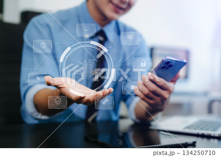 Young professional using smartphone with digital circuit UI hologram. Concept of AI, cybersecurity, innovation, Young professional using smartphone with digital circuit UI hologram. Concept of AI, cybersecurity, innovation, 134250710