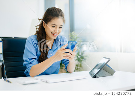 Business woman using tablet and laptop for doing math finance on an office desk, tax, report, accounting, statistics 134250772