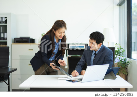 Asian businessman and woman workers talking on the smartphone and using laptop Professionals in Teamwork Finance, Marketing, and Success Asian businessman and woman workers talking on the smartphone and using laptop Professionals in Teamwork Finance, Marketing, and Success 134250882
