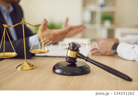 Lawyer professional objects closeup, judge hammer, balance scale justice symbol on table 134251262