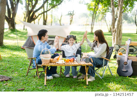 Happy parents and daughter Bakery and Bread Fruit enjoy in a sunny garden. A joyful summer picnic full of love, food for family, outdoor Happy parents and daughter Bakery and Bread Fruit enjoy in a sunny garden. A joyful summer picnic full of love, food for family, outdoor 134251457