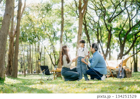 Happy parents and daughter Bakery and Bread Fruit enjoy in a sunny garden. A joyful summer picnic full of love, food for family, outdoor Happy parents and daughter Bakery and Bread Fruit enjoy in a sunny garden. A joyful summer picnic full of love, food for family, outdoor 134251529