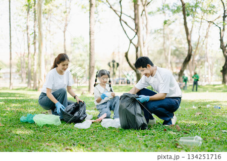 Asian parents and child collect bottles at the park, sharing love, teamwork, and care. A green lifestyle moment promoting recycling, unity Asian parents and child collect bottles at the park, sharing love, teamwork, and care. A green lifestyle moment promoting recycling, unity 134251716