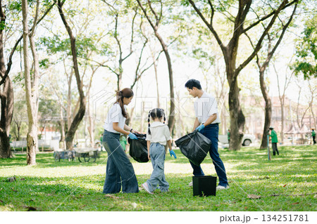 Asian parents and child collect trash in the forest, promoting recycling, unity, and ecology. A heartwarming scene of love, care, teamwork Asian parents and child collect trash in the forest, promoting recycling, unity, and ecology. A heartwarming scene of love, care, teamwork 134251781