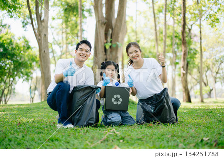 Asian parents and child collect bottles at the park, sharing love, teamwork, and care. A green lifestyle moment promoting recycling, unity Asian parents and child collect bottles at the park, sharing love, teamwork, and care. A green lifestyle moment promoting recycling, unity 134251788