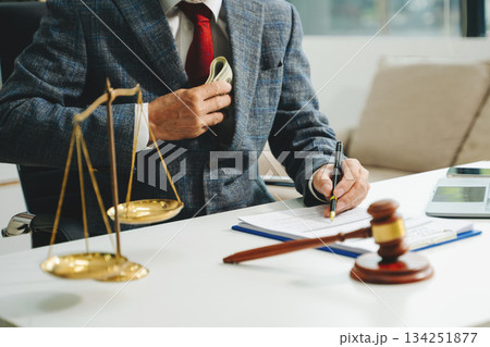 justice and law concept. Male judge in a courtroom the gavel, working with smart phone and laptop and digital tablet justice and law concept. Male judge in a courtroom the gavel, working with smart phone and laptop and digital tablet 134251877