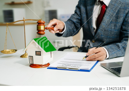 Real Estate Lawyer And House Foreclosure Law. House model, hammer judge gavel on table with white background. 134251878
