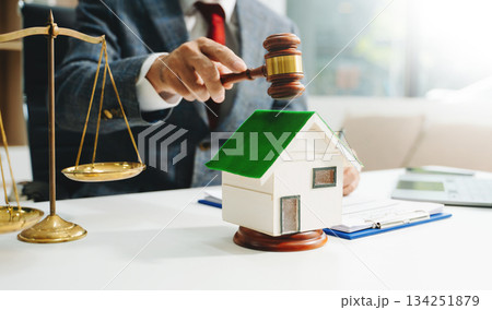 Real Estate Lawyer And House Foreclosure Law. House model, hammer judge gavel on table with white background. Real Estate Lawyer And House Foreclosure Law. House model, hammer judge gavel on table with white background. 134251879